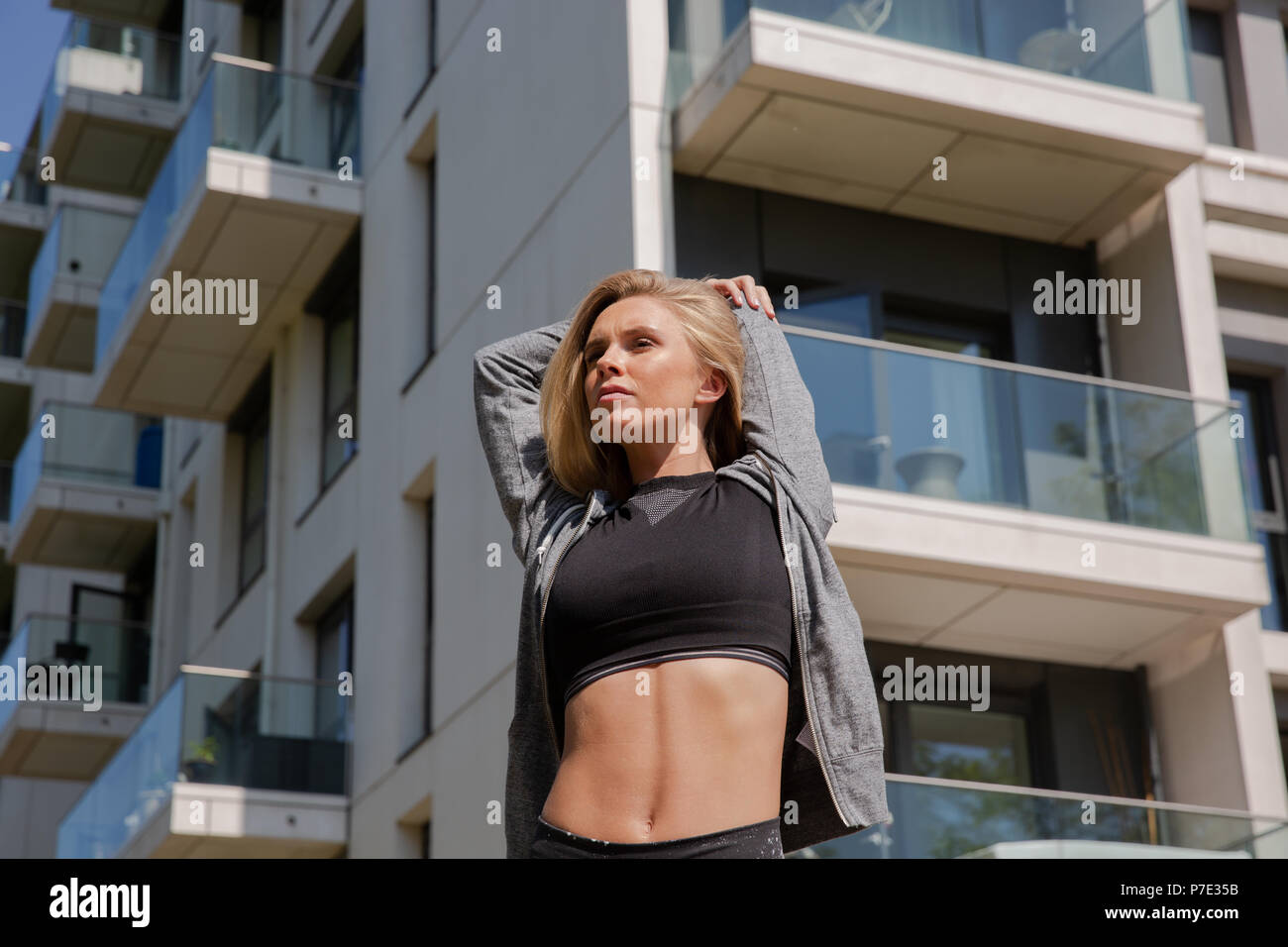 Young woman stretching arms hi-res stock photography and images - Alamy