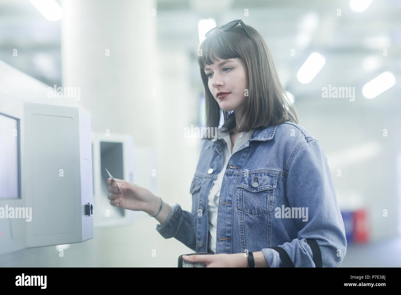 Woman using identity card on security machine Stock Photo