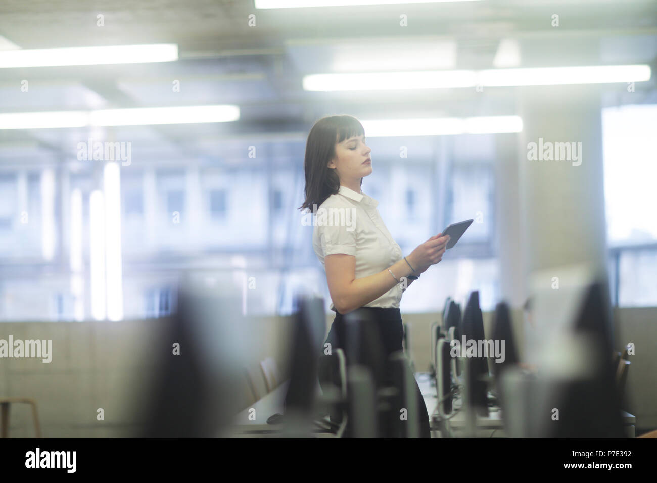 Businesswoman in office using digital tablet Stock Photo