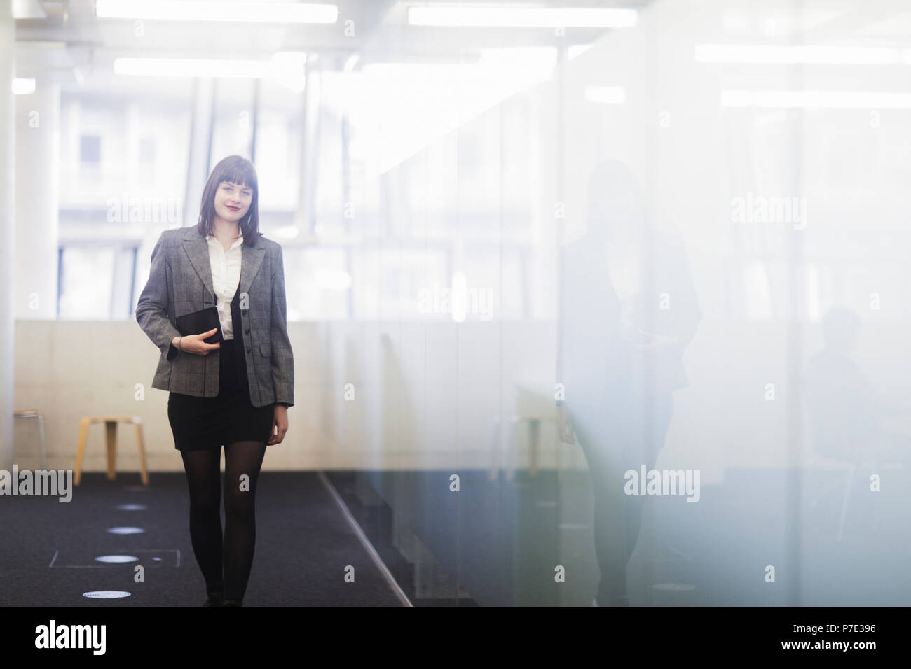 Businesswoman in office holding digital tablet Stock Photo