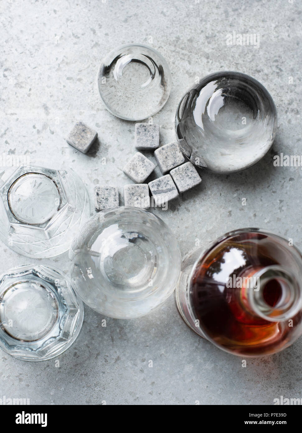 Bottle and glasses with whiskey stones, overhead view Stock Photo