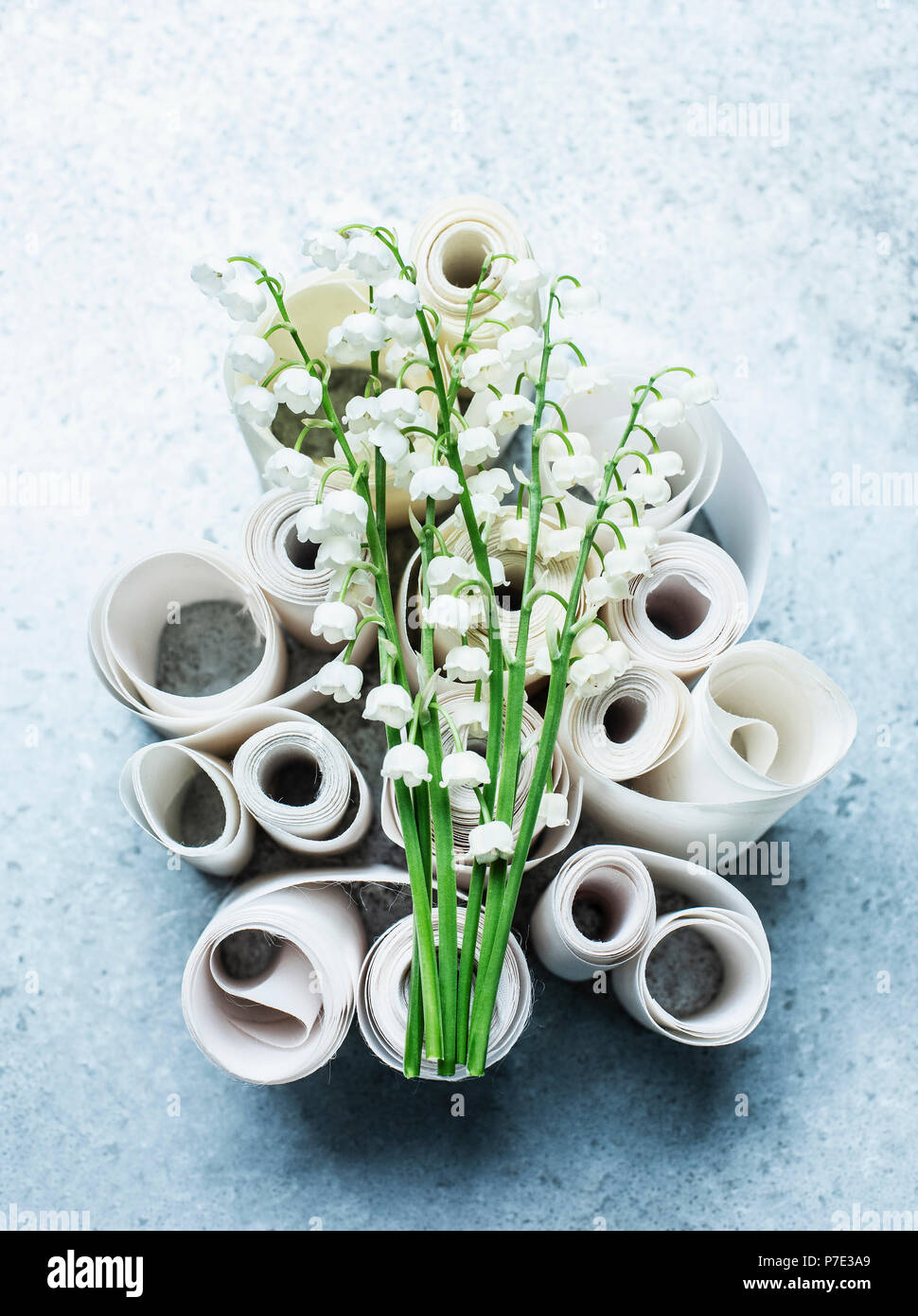 Lily of the valley cut flowers on curled ribbons, overhead view Stock Photo