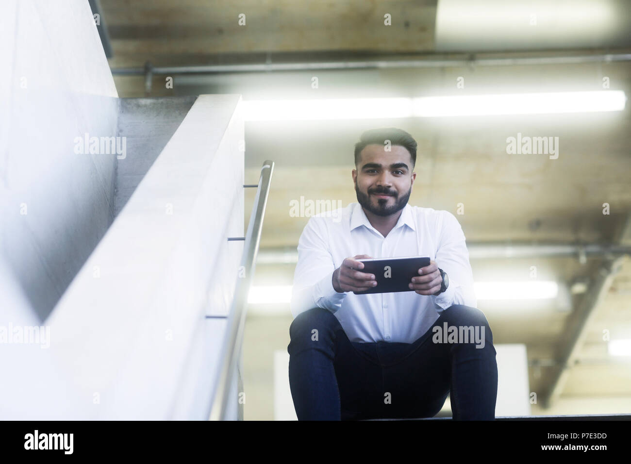 Young man using digital tablet in office Stock Photo
