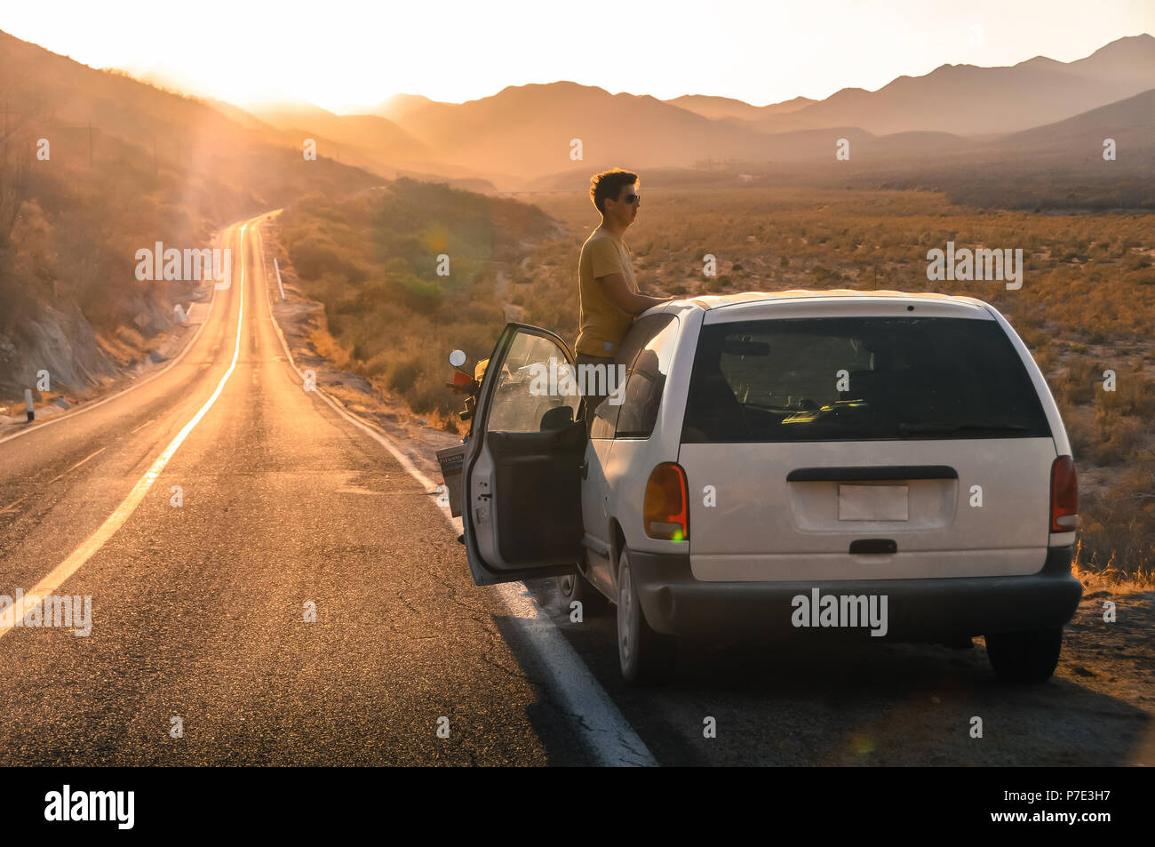 Man by car on open road, San Jose del Cabo, Baja California Sur, Mexico Stock Photo