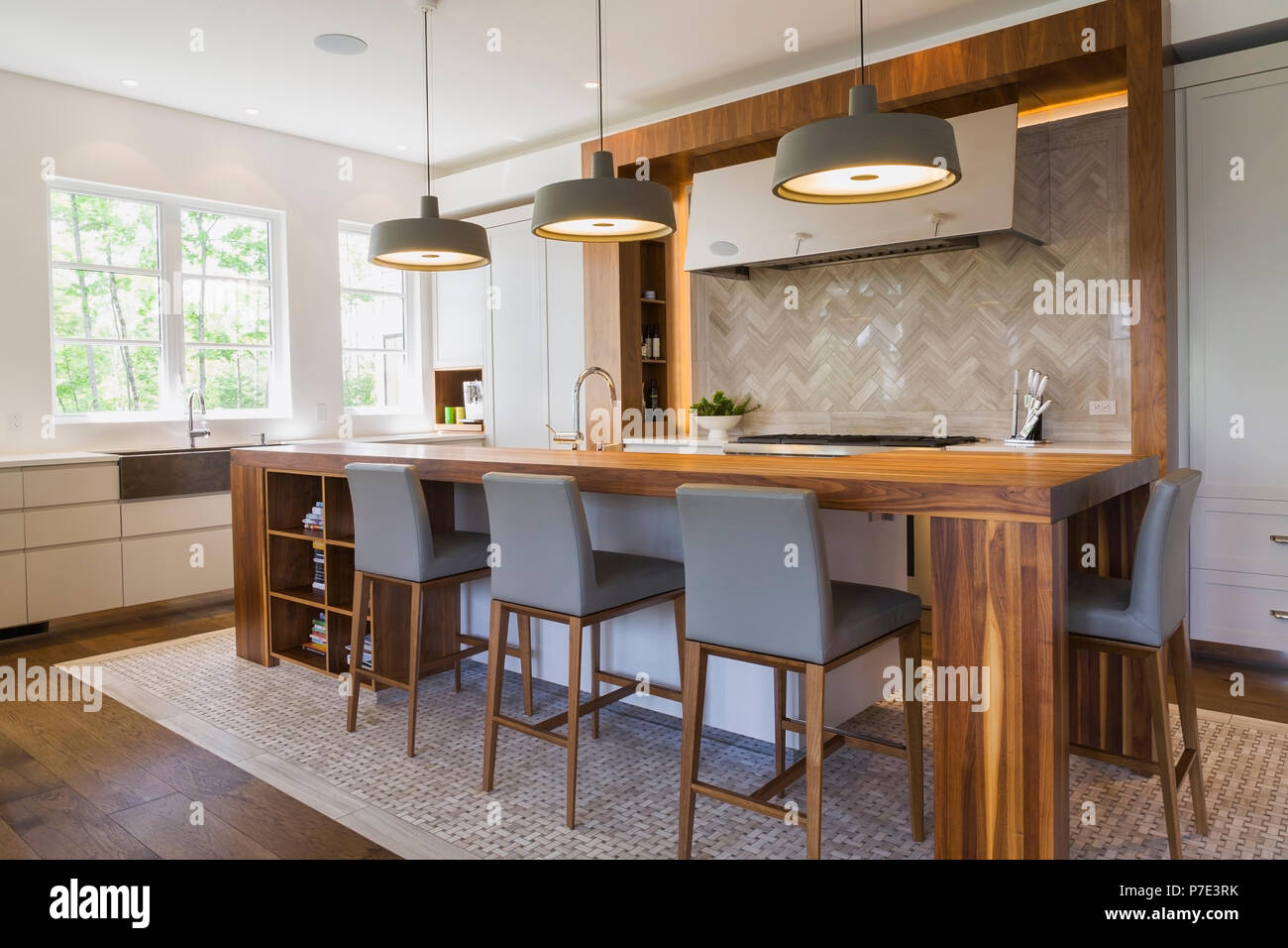 Walnut wood kitchen island in a luxurious contemporary home Stock Photo