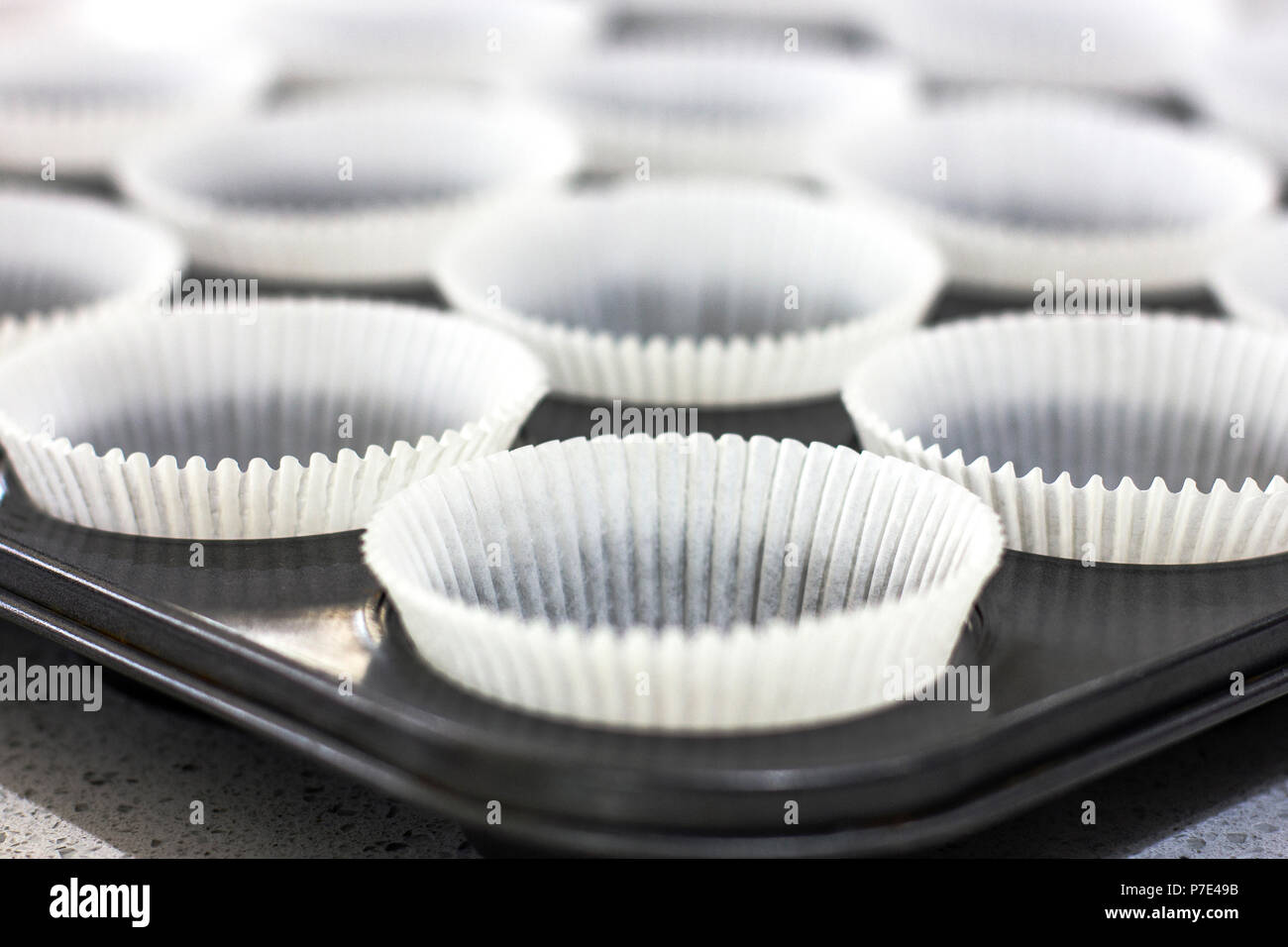 Empty paper forms for muffins and cupcakes in a metal tray Stock Photo ...