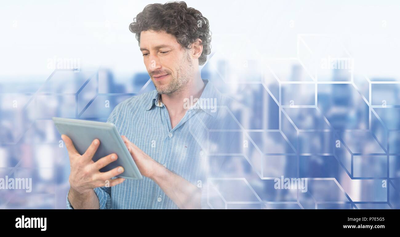 Man using laptop with geometric city transition Stock Photo