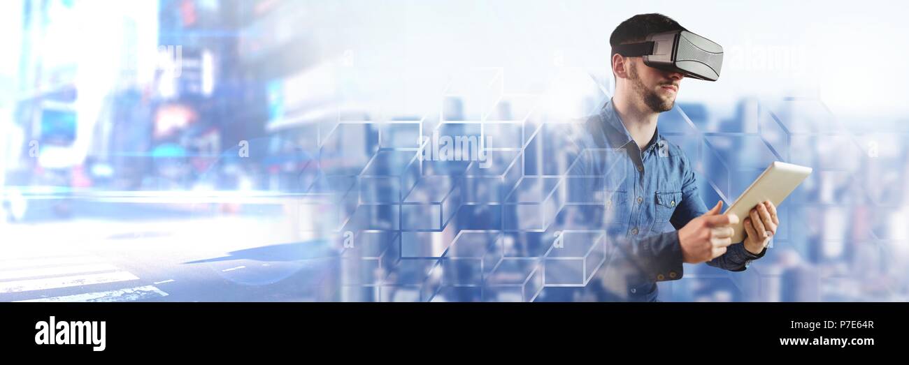 Man using tablet wearing virtual reality headset with city transitions Stock Photo