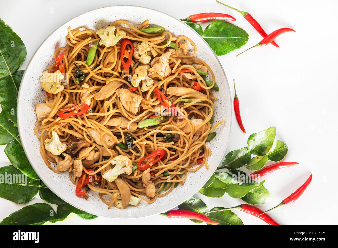 spicy asian wok stir fry spaghetti with chicken and thai spices Stock Photo  - Alamy