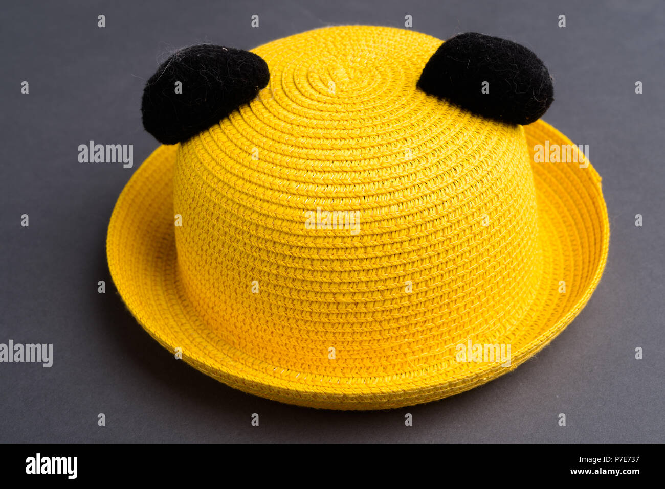 Yellow Hat Against Gray Background Stock Photo