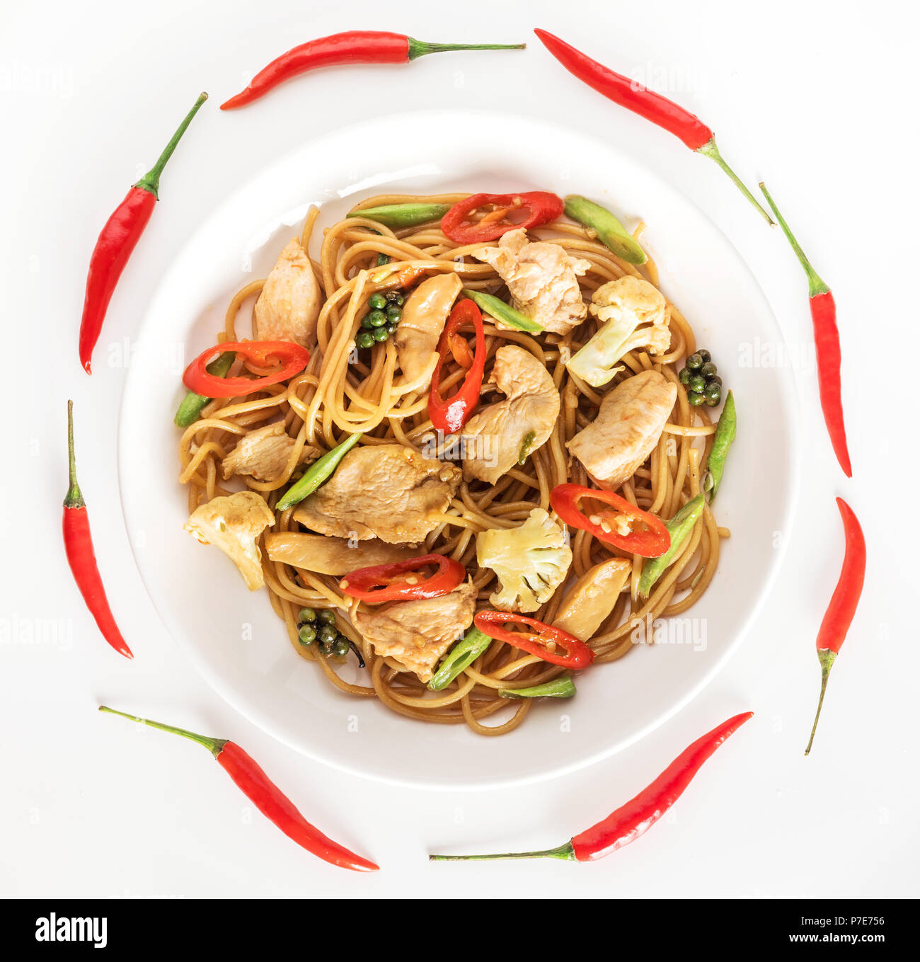 spicy asian wok stir fry spaghetti with chicken and thai spices Stock