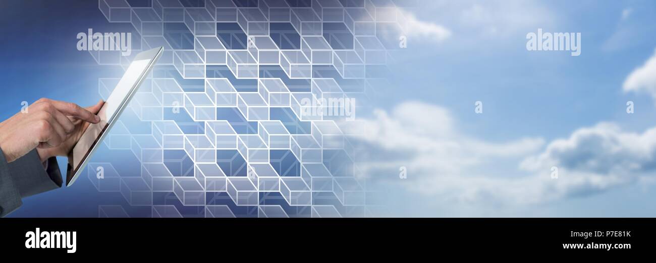 Hand using tablet with geometric transition of sky Stock Photo