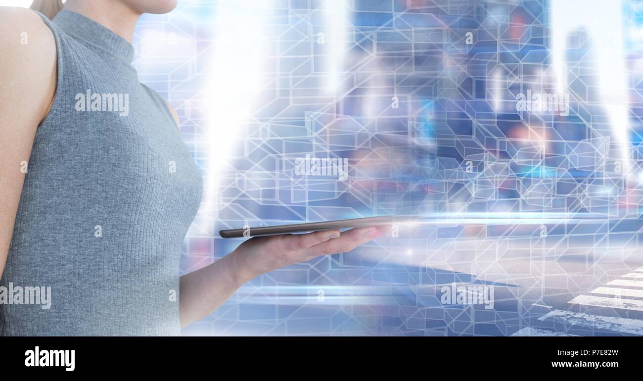 Woman using tablet with geometric city transition Stock Photo