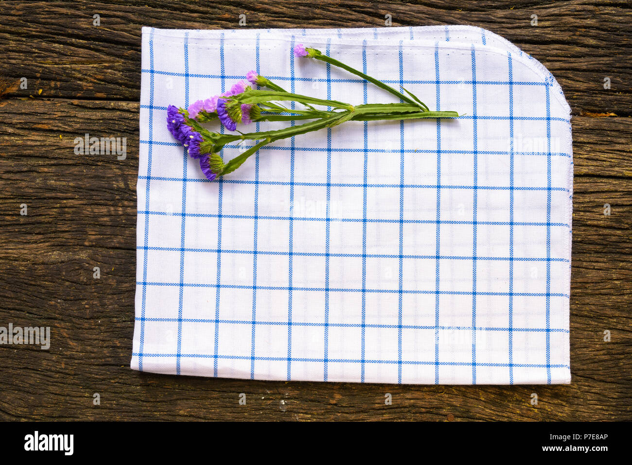 Table Cloth And Flower On Old Wooden Table With Copyspace Stock Photo
