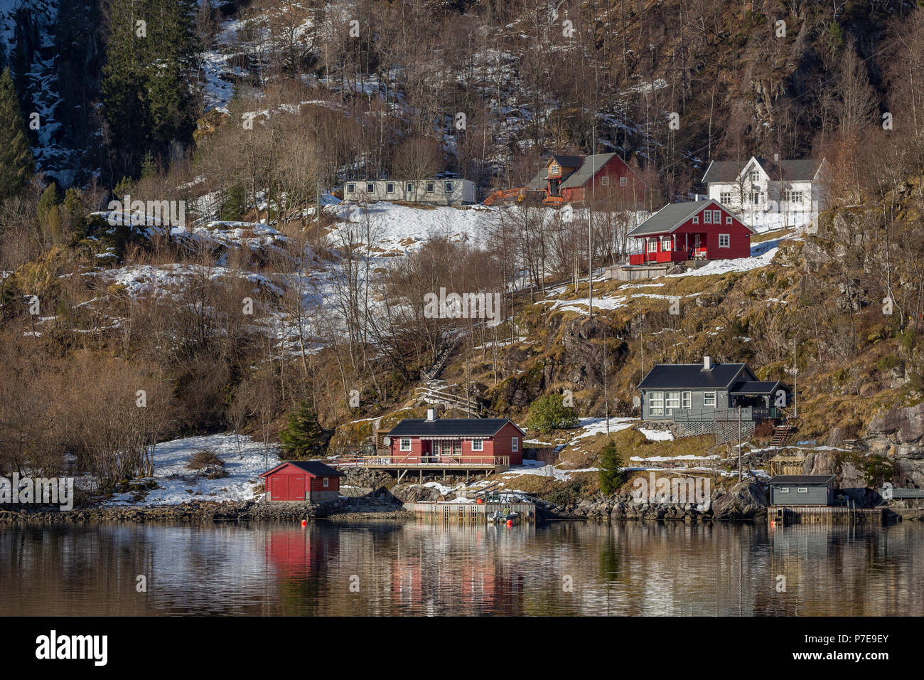 Village built on the shoreline of Osterfjorden, Norway. Taken from the Bergen to Mostraumen cruise. Stock Photo