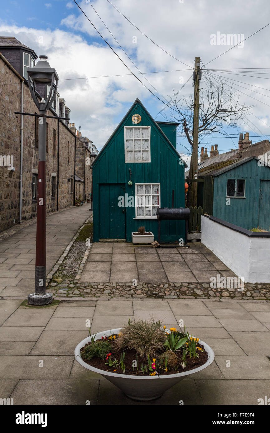 Turquoise green outhouse in the quaint streets around Footdee, Aberdeen, Scotland, UK. Stock Photo