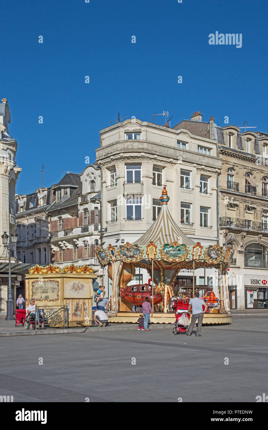 Charming old fashioned traditional carousel children’s roundabout in Place de l’Hotel de Ville St Quentin Aisne France Stock Photo