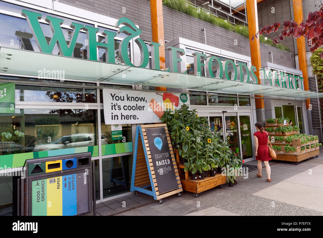 A woman entering the Whole Foods Market grocery store on Cambie Street in Vancouver, BC, Canada Stock Photo