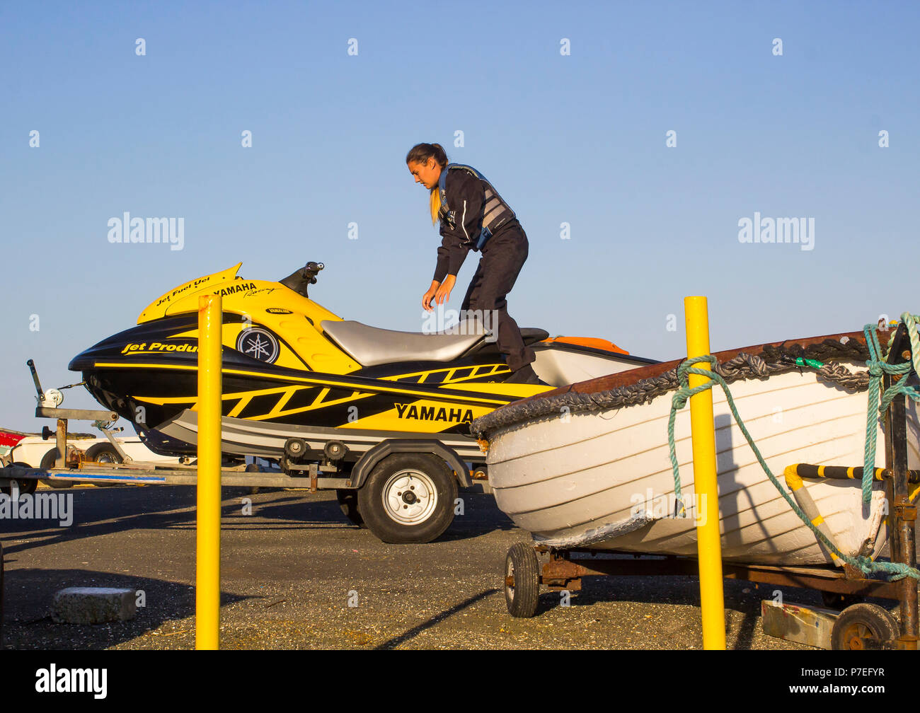 29 June 2018 A young woman in wet gear sits on a powerful Yamaha Jet-Ski at Groomsport Harbour Northern Ireland in preparation for launching Stock Photo