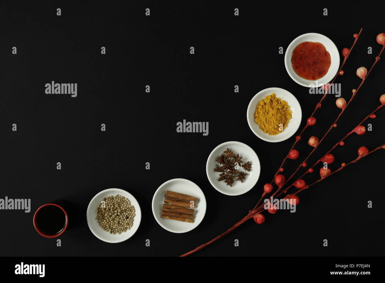 Asian spices, herbs and cooking ingredients on black background. Stock Photo