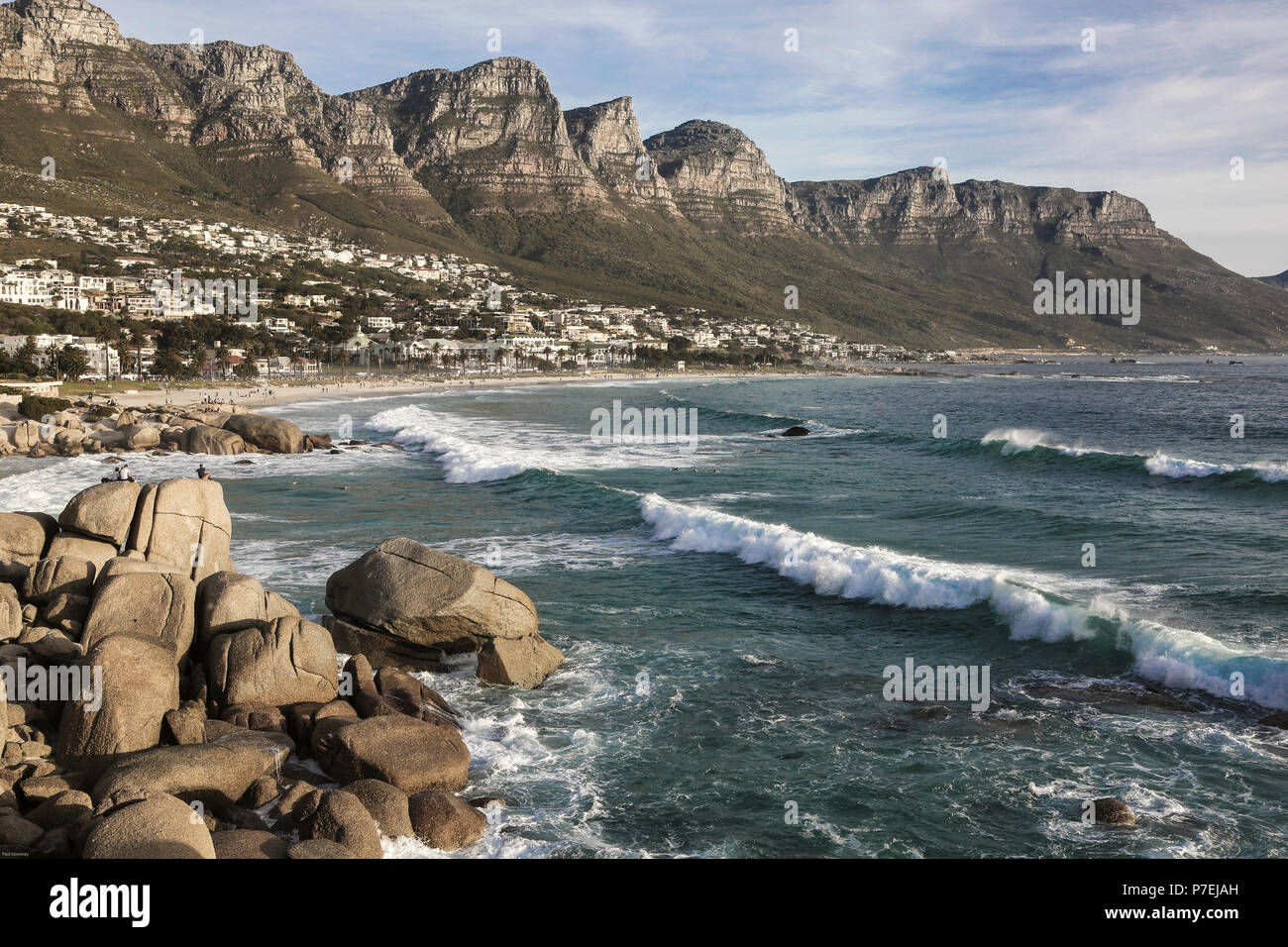 People enjoy a warm winters day at Camps Bay, Cape Town, South Africa Stock Photo