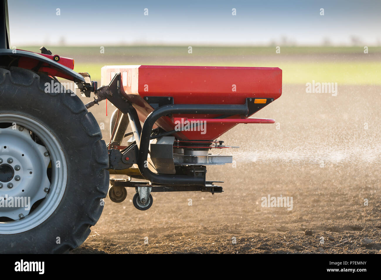 Tractor spreading artificial fertilizers in field Stock Photo Alamy