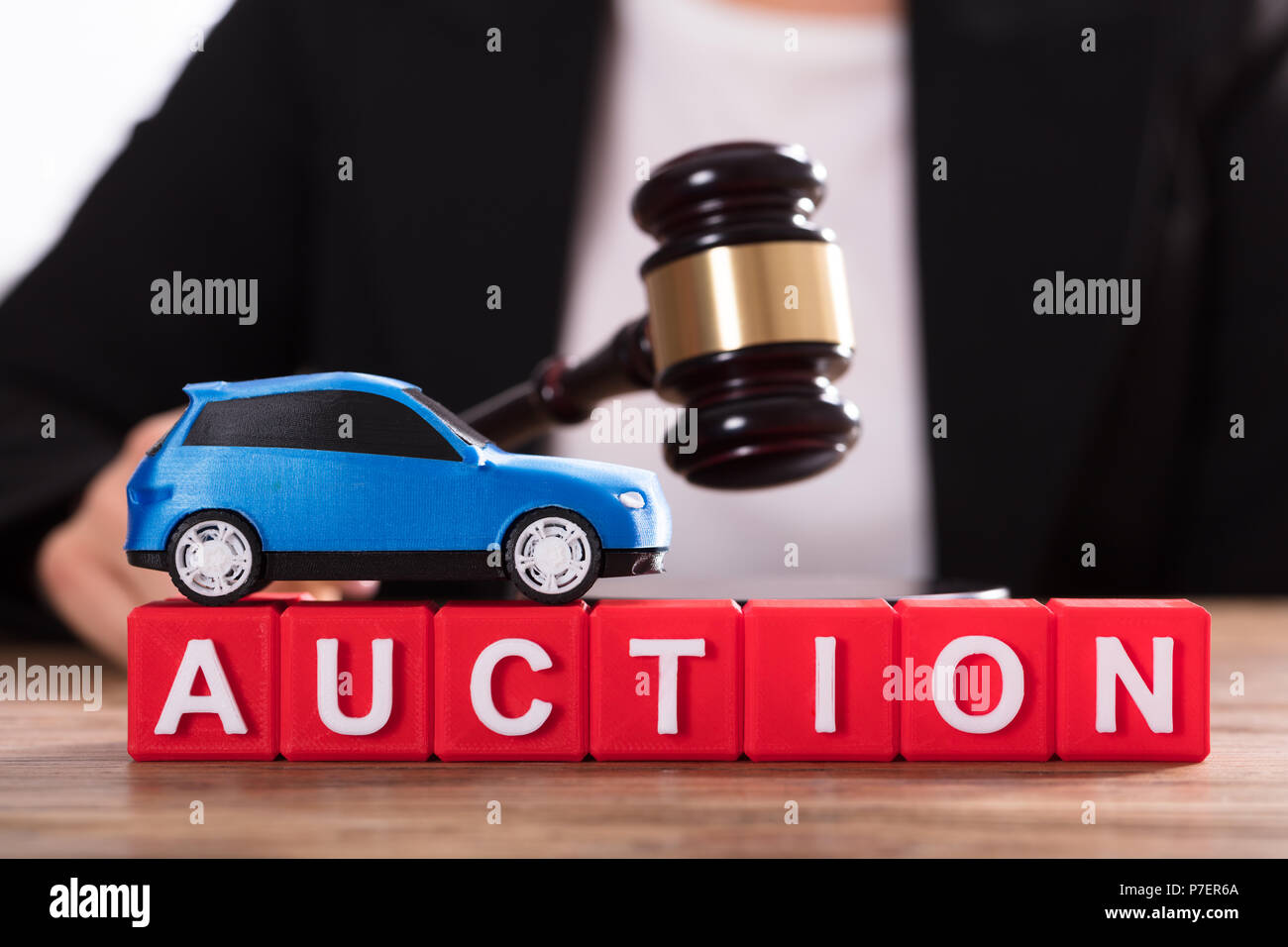 Small Blue Car Over Auction Cubic Blocks Stock Photo