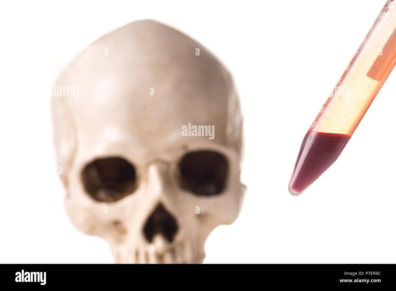 Blood sample or test tube with red liquid and blurry skull isolated in white background Stock Photo