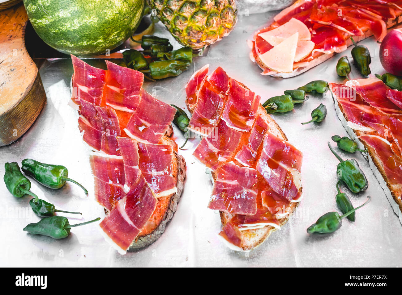 Delicious tasty street food at a market in Spain. Iberian ham toast