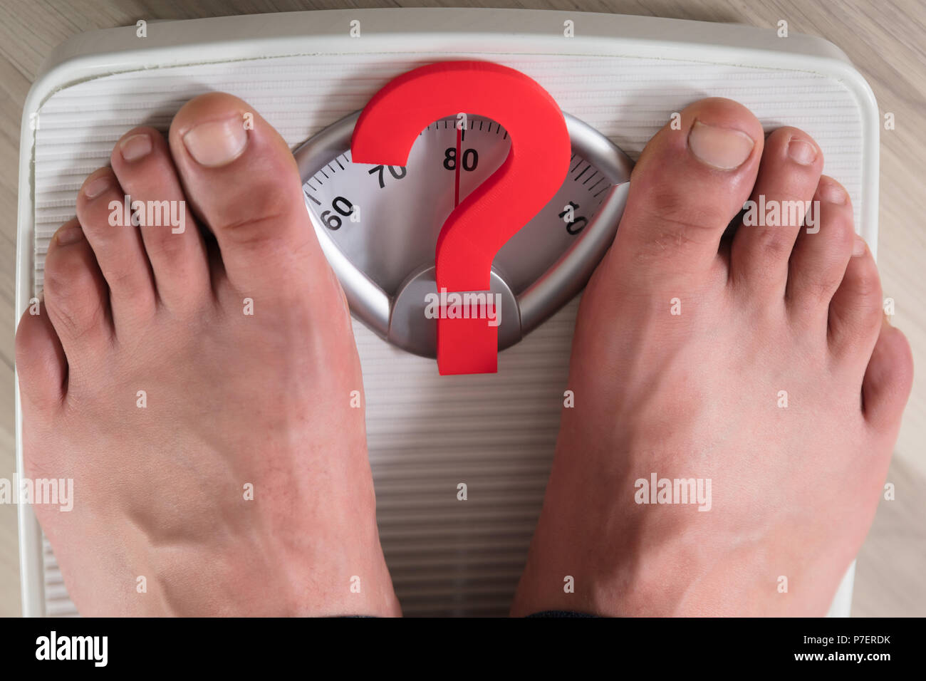 https://c8.alamy.com/comp/P7ERDK/persons-feet-standing-on-weight-scale-with-red-question-mark-sign-P7ERDK.jpg