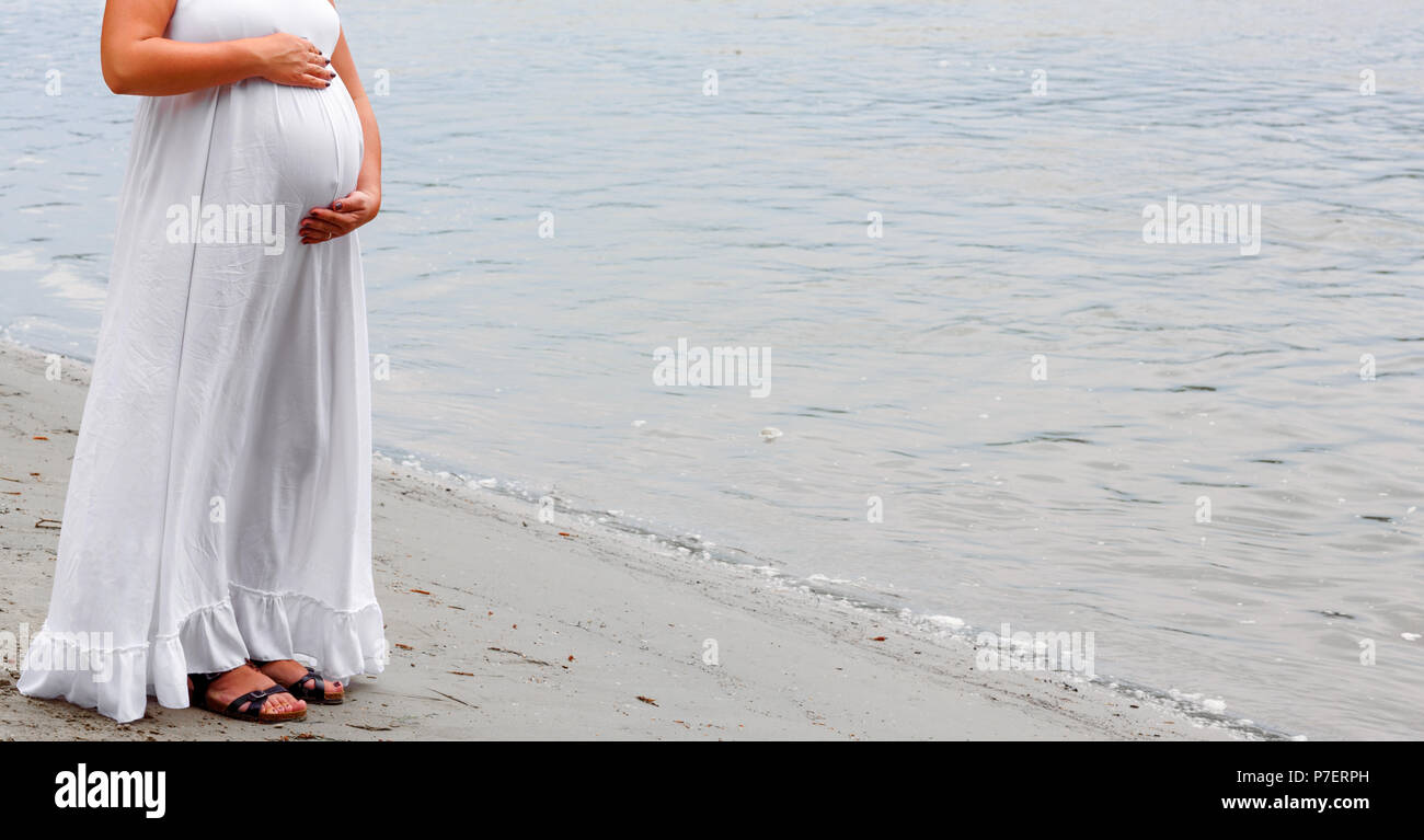 Beautiful belly of pregnant woman on the river bank Stock Photo Alamy