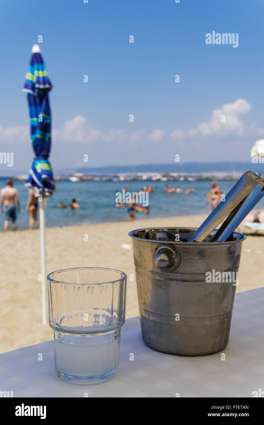 Greek tavern alcoholic drink. Ouzo on the rocks with ice cubes