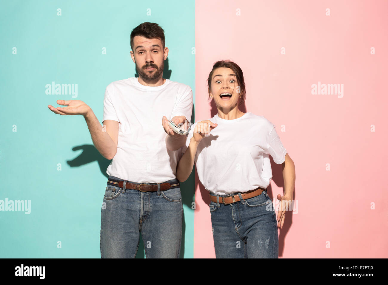 Closeup portrait of young couple, man, woman. One being excited happy ...