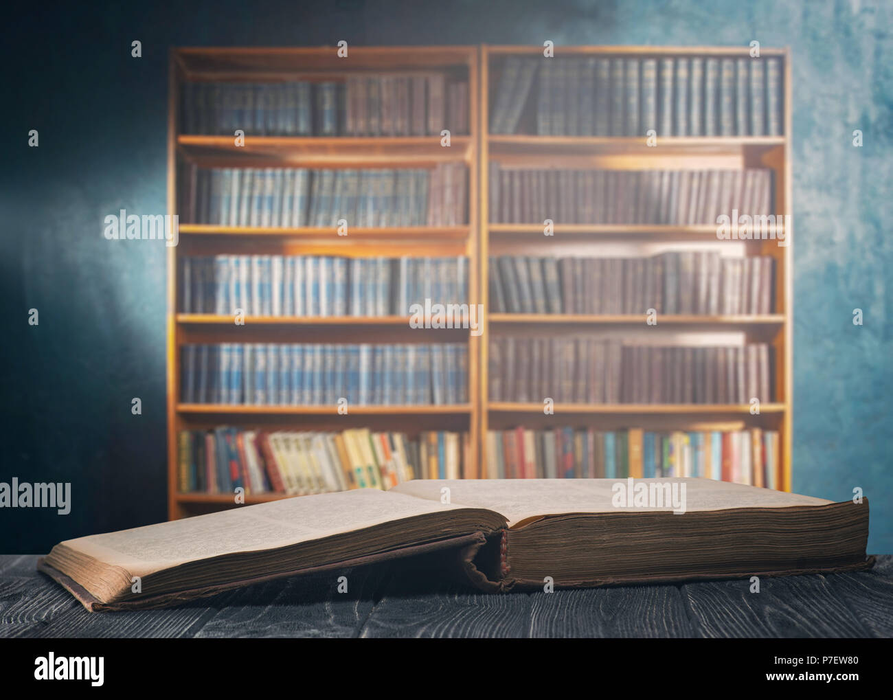 An open thick book and a bookcase Stock Photo Alamy