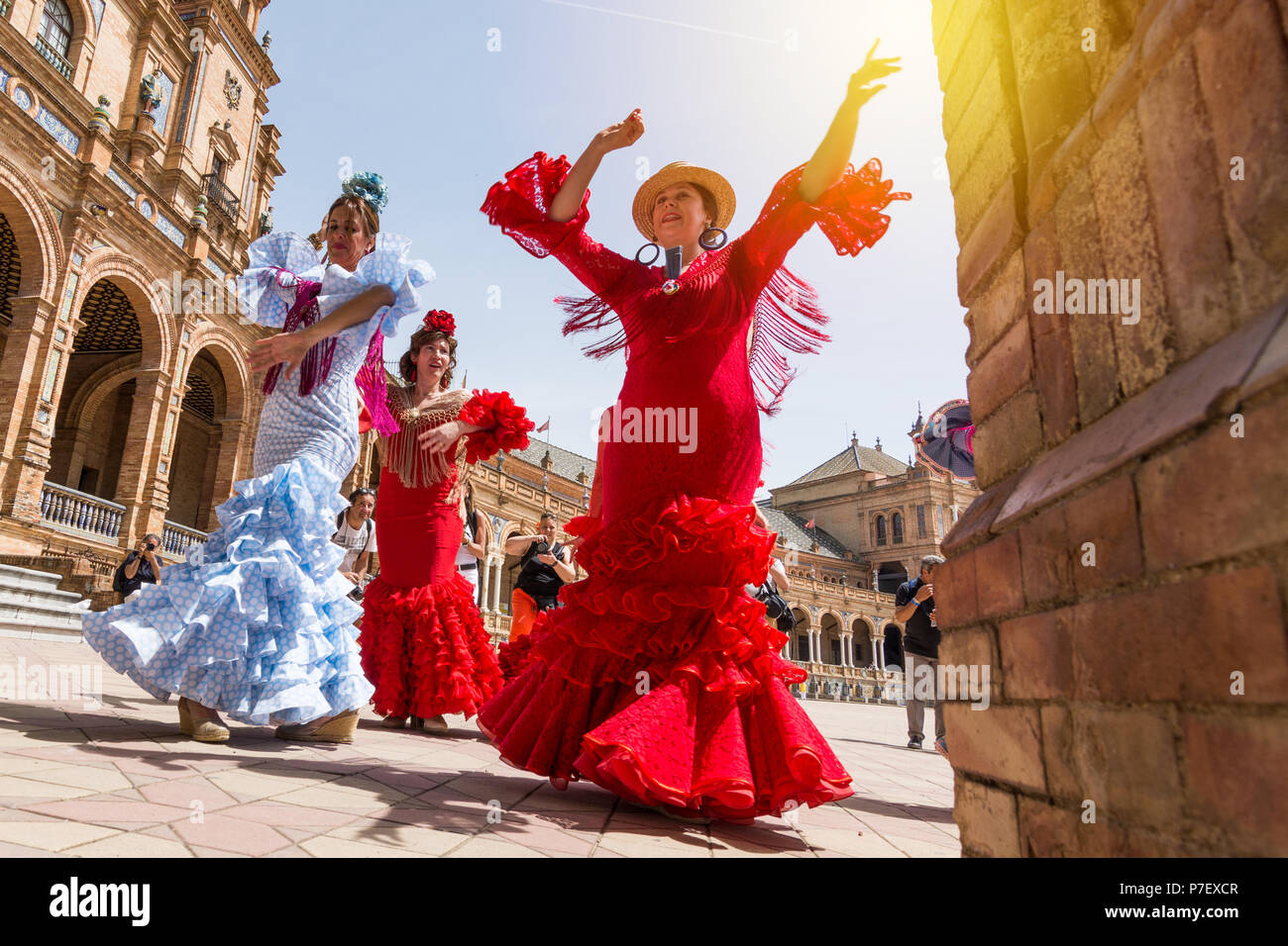 SEVILLE, SPAIN - MAY 2017: Young women dance flamenco on Plaza de Espana during famous Feria festival Stock Photo