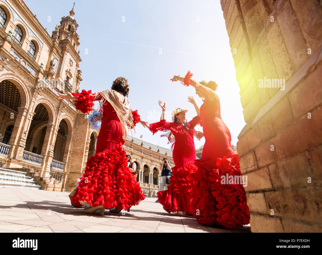 SEVILLE, SPAIN - MAY 2017: Young women dance flamenco on Plaza de Espana during famous Feria festival Stock Photo