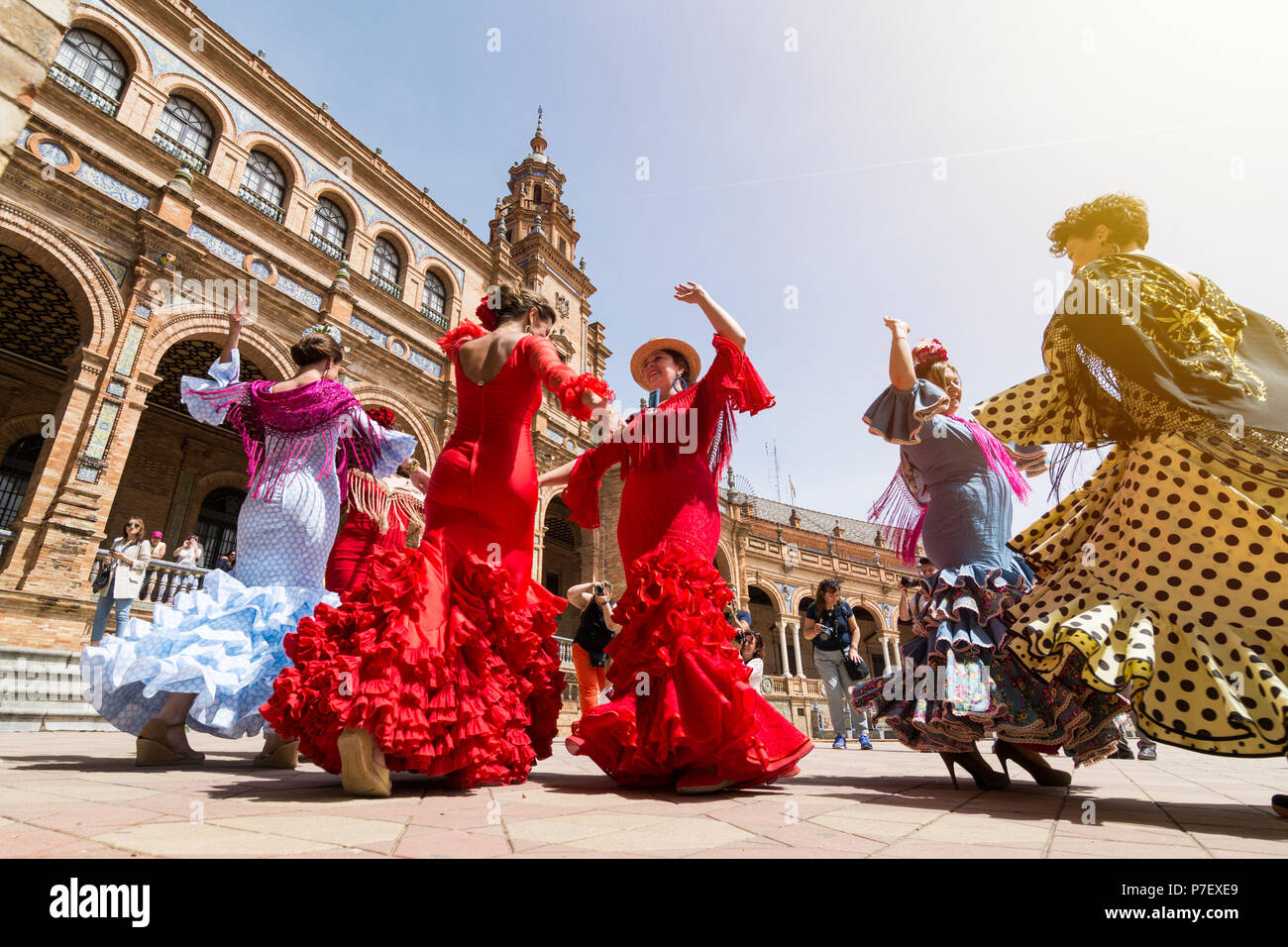 SEVILLE, SPAIN - MAY 2017: Young women dance flamenco on Plaza de Espana during famous Feria festival Stock Photo