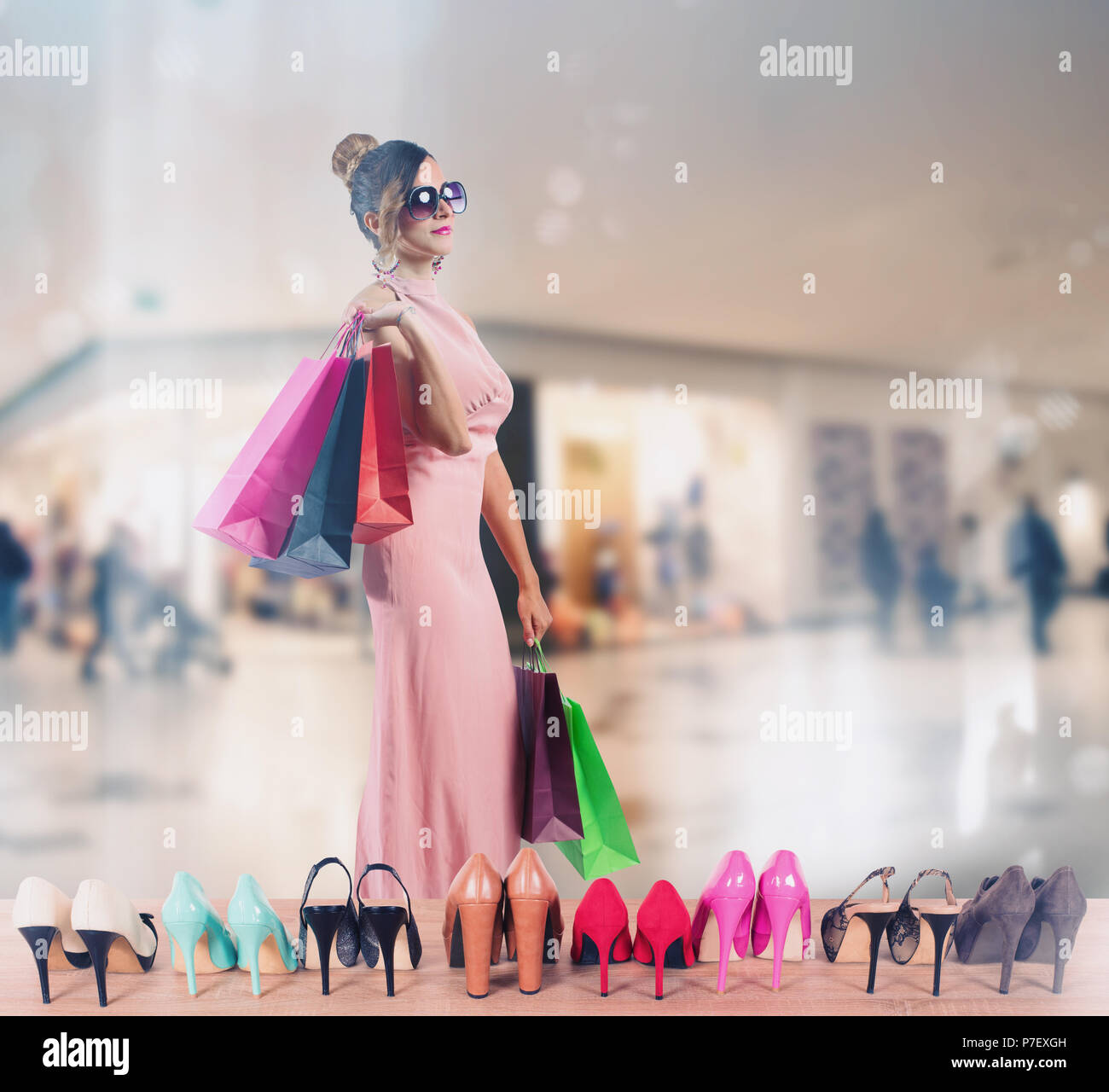 Girl full of bags does shopping in a store Stock Photo