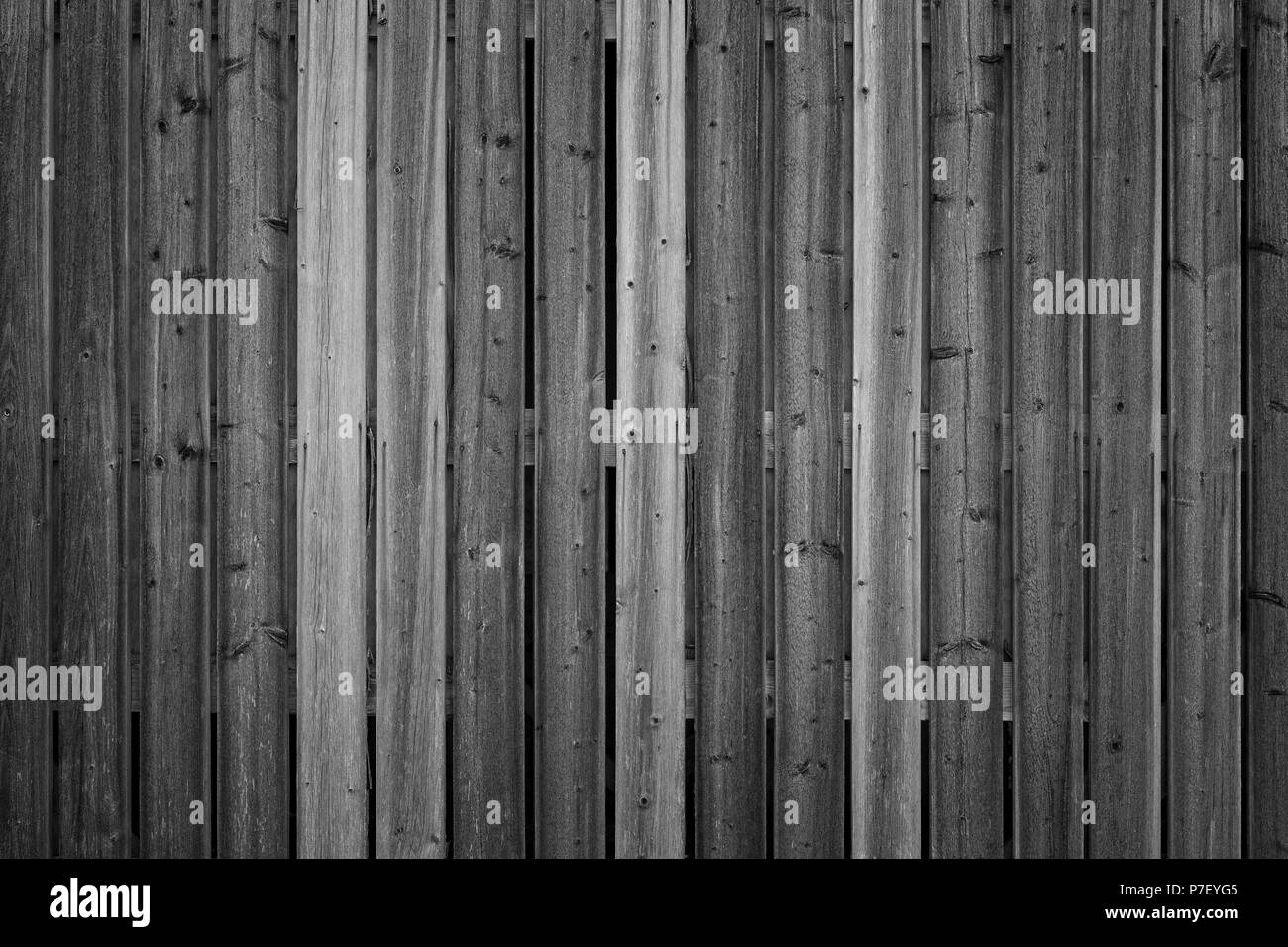 Full frame background of an unpainted wood board wall in black and white with vignette Stock Photo