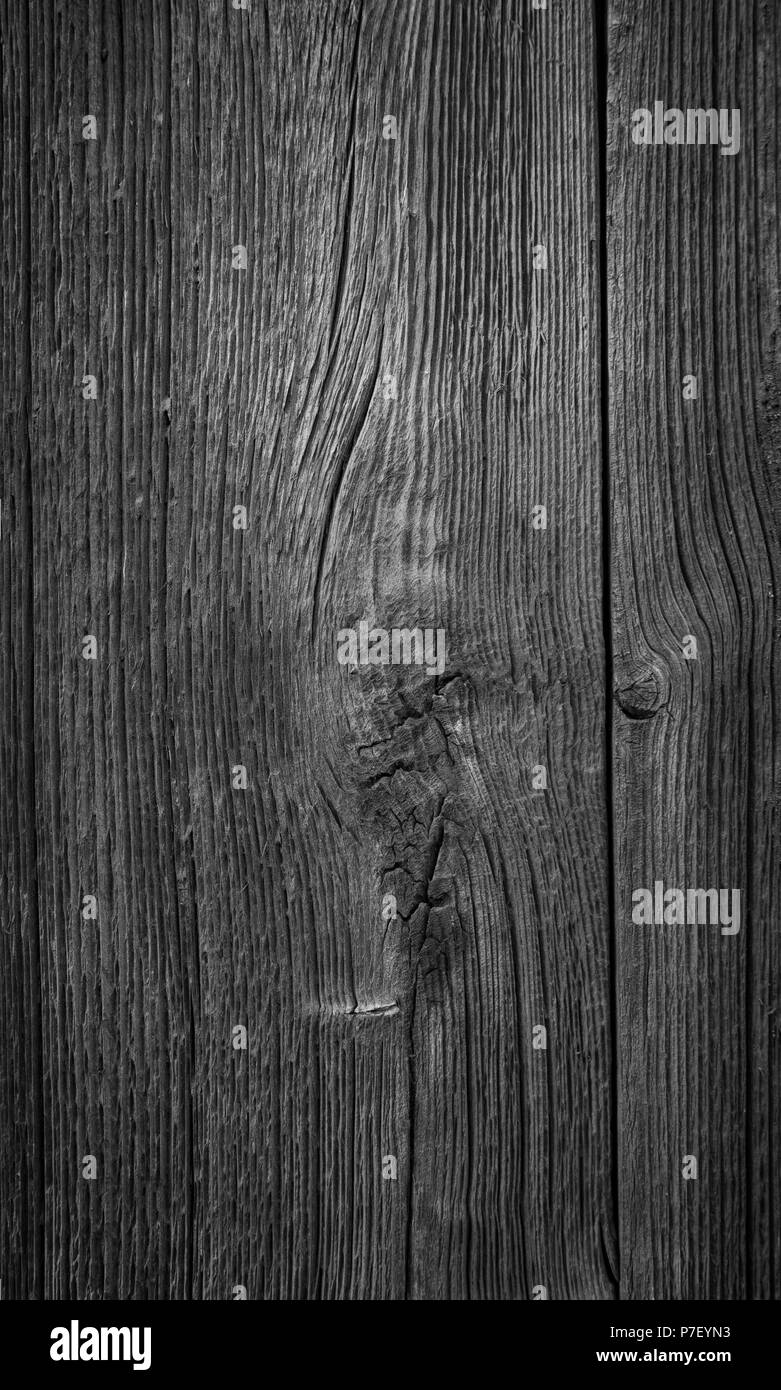 Close-up of an old and unpainted rustic wood board texture background in black and white with vignette Stock Photo
