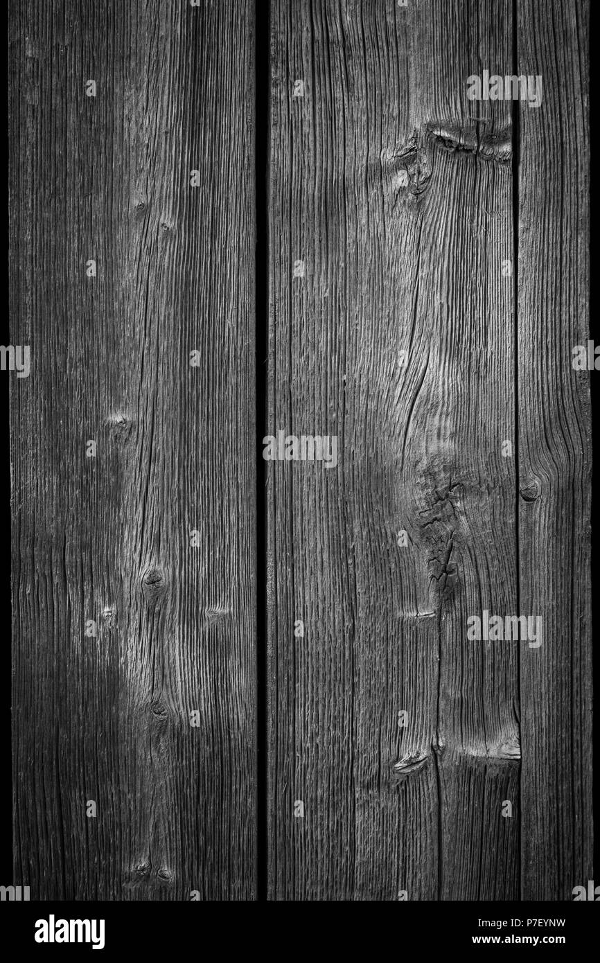 Close-up of an old and unpainted rustic wood board texture background in black and white with vignette Stock Photo