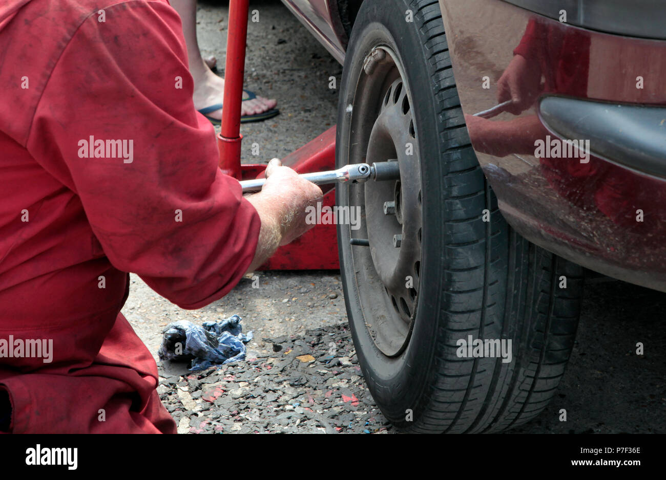 a MOTOR mechanic working on AND FIXING cars in north WEST London, UK
