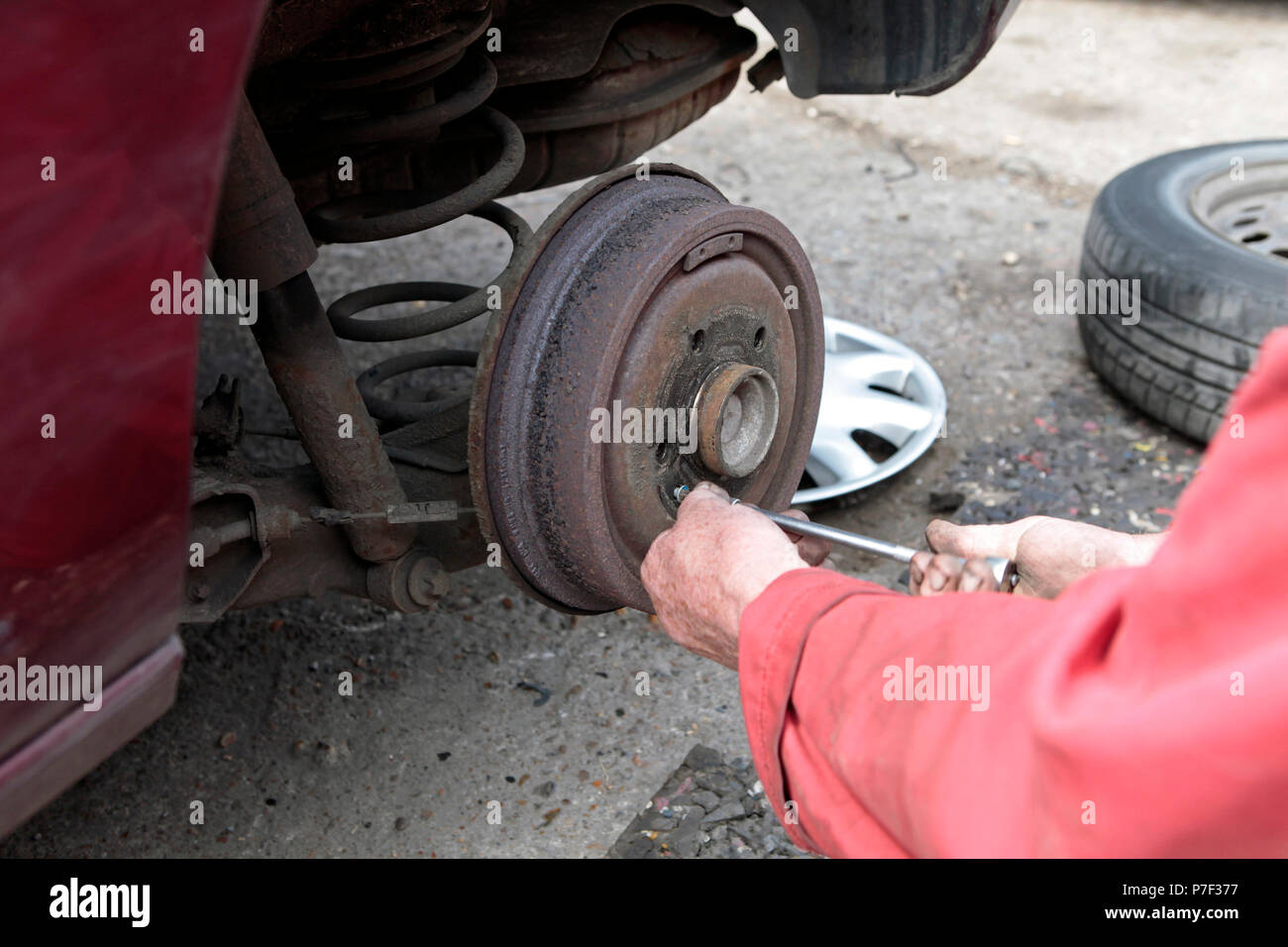 a MOTOR mechanic working on AND FIXING cars in north WEST London, UK