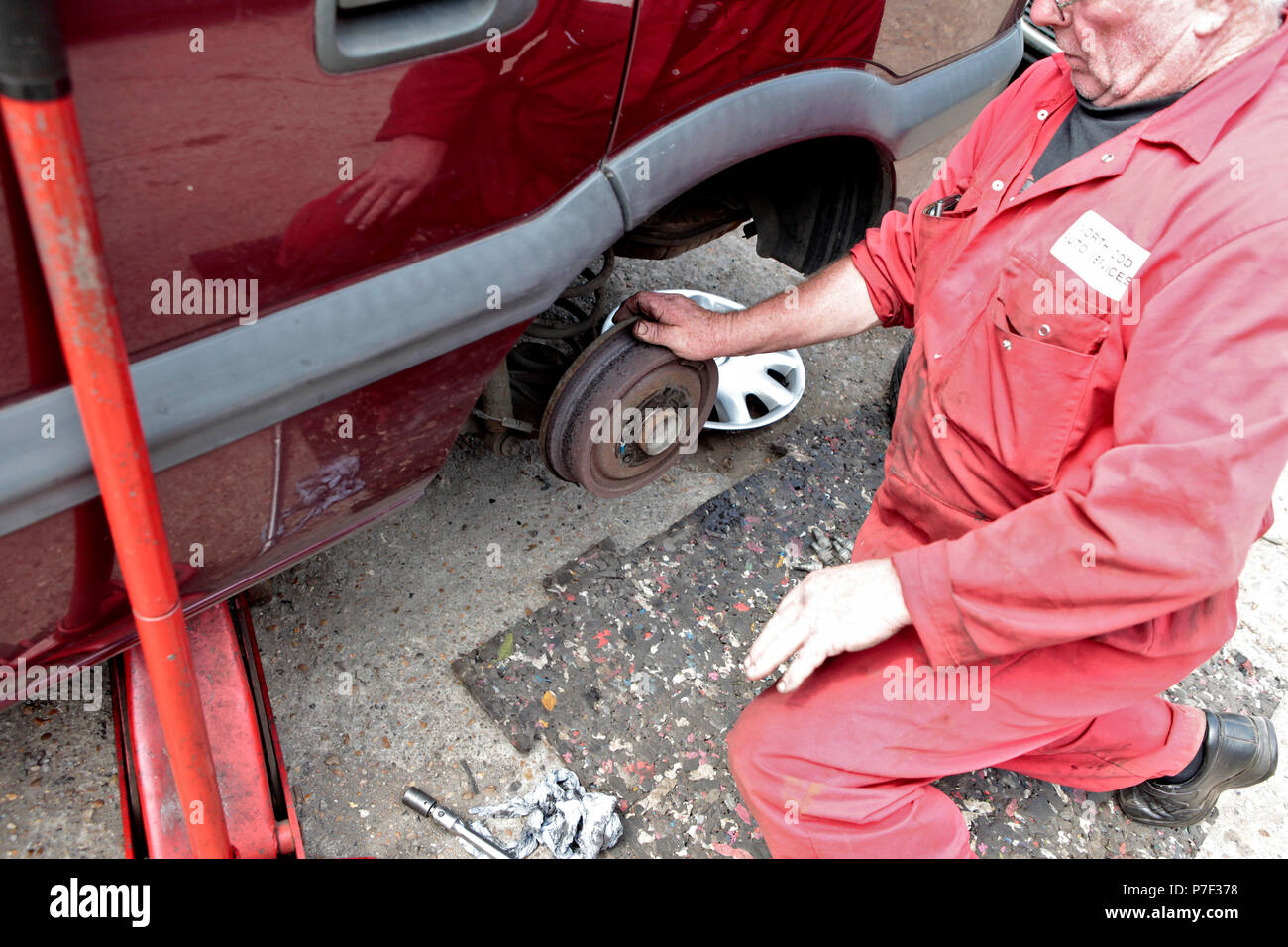 a MOTOR mechanic working on AND FIXING cars in north WEST London, UK ...