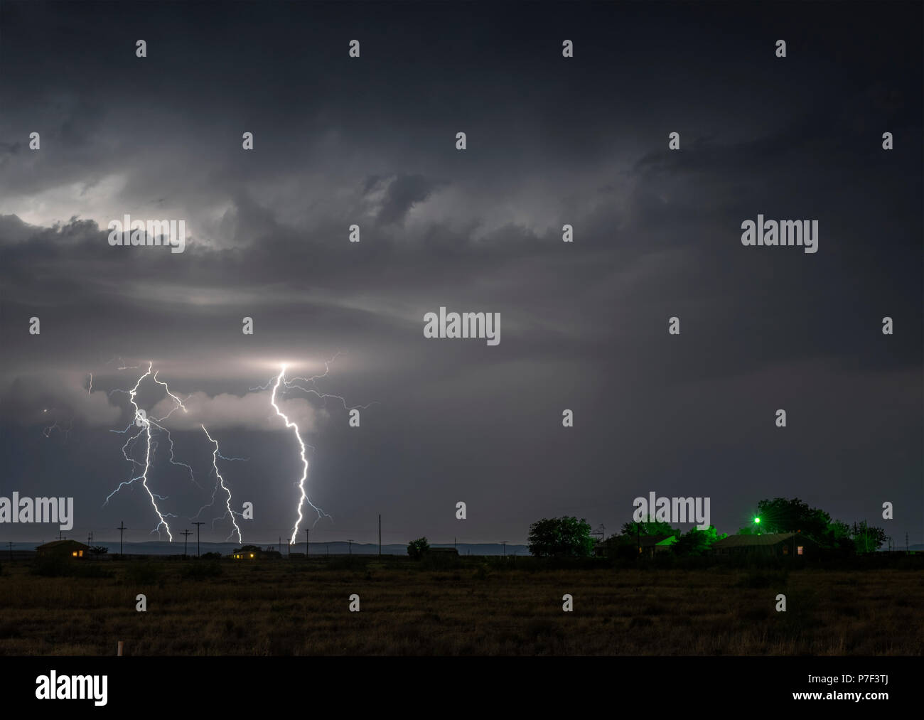 A large lightning strike at night in a rural area of Roswell, New