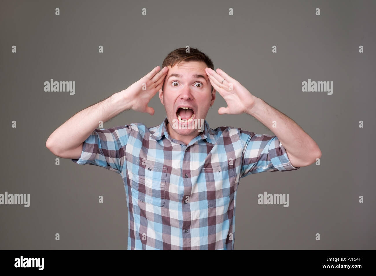 Portrait of young european man with shocked facial expression. He can not believe his luck or success. Stock Photo