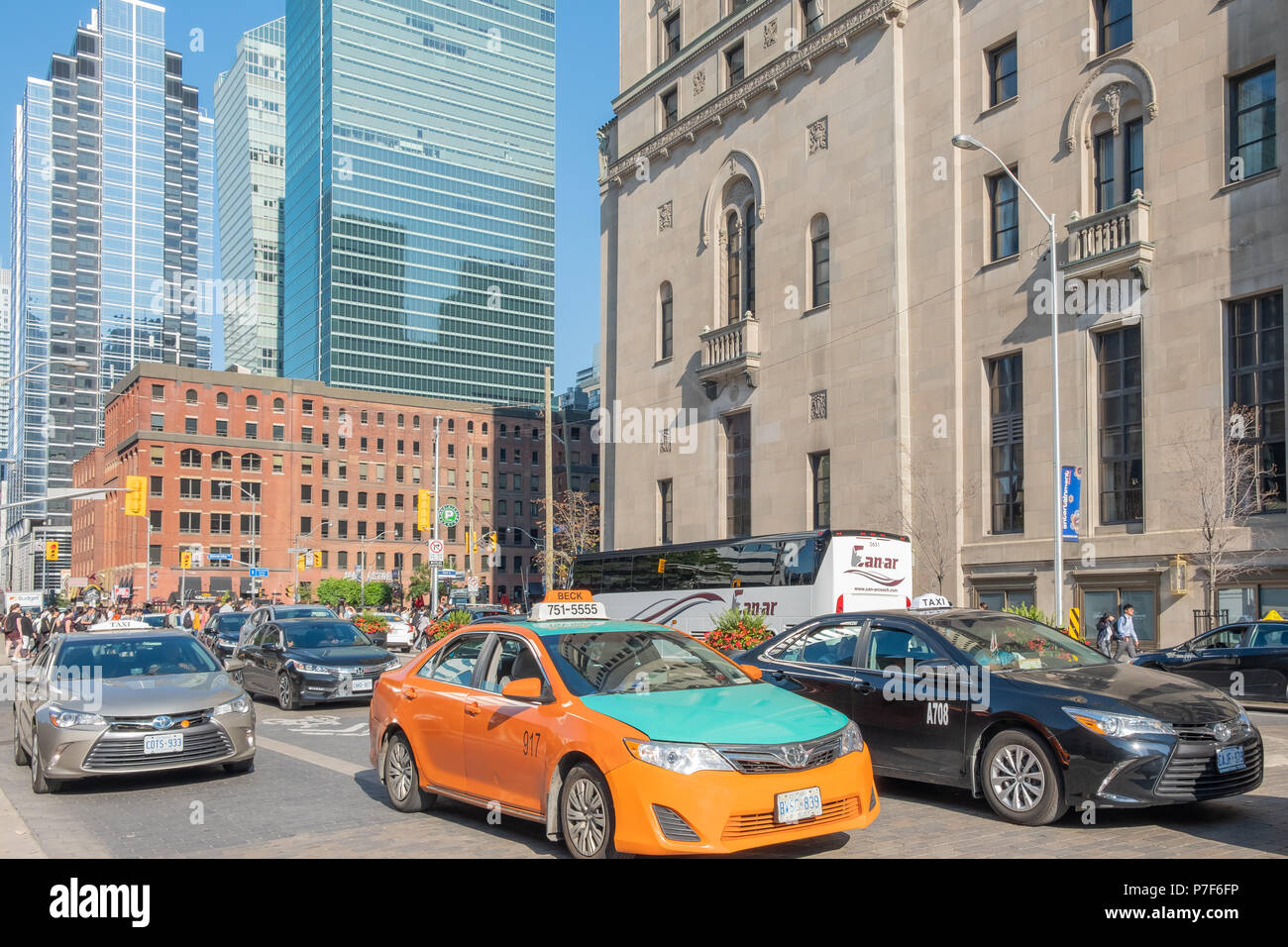 Morning rush hour traffic along Front Street in Toronto near the Royal York Hotel.  Toronto has some of the worst traffic problems in the world. Stock Photo