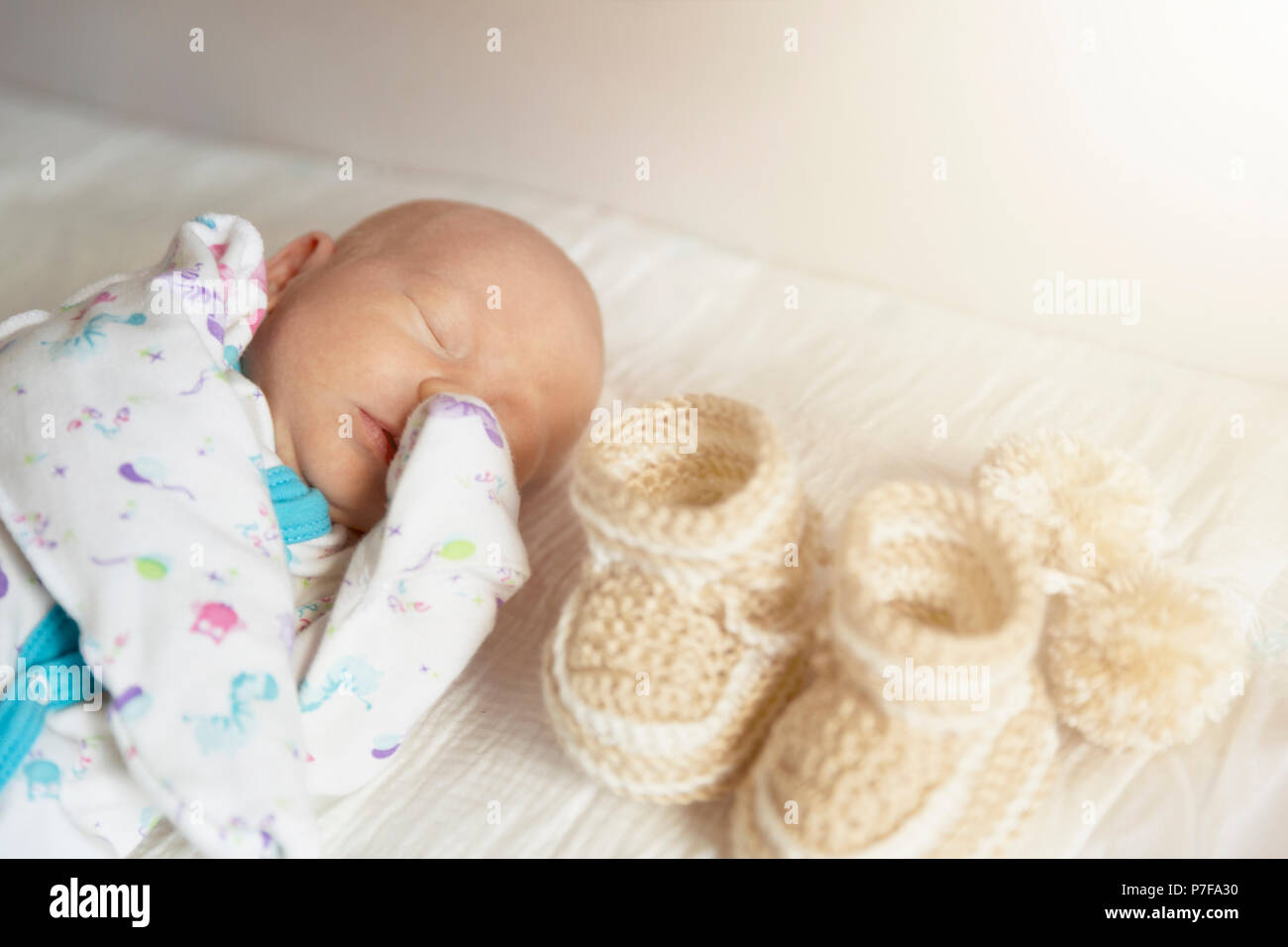 Cute newborn baby boy sleeps in a nursery while changing diapers Stock
