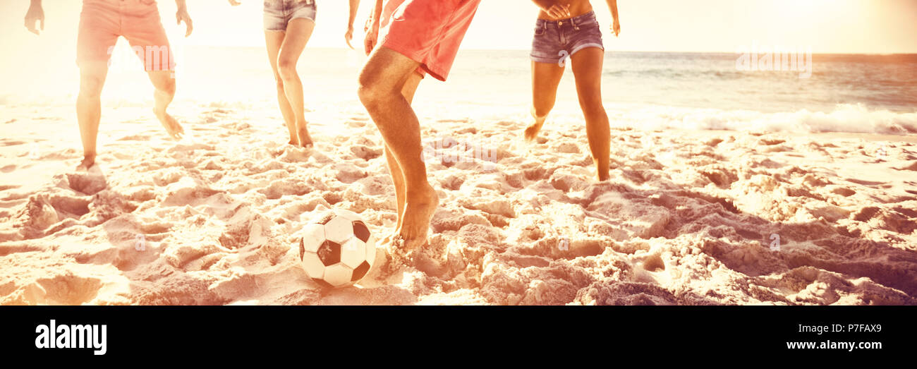Cheerful friends playing football Stock Photo