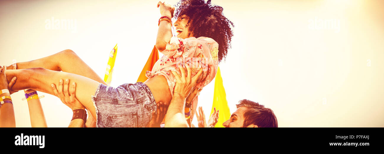 Happy hipster woman crowd surfing Stock Photo